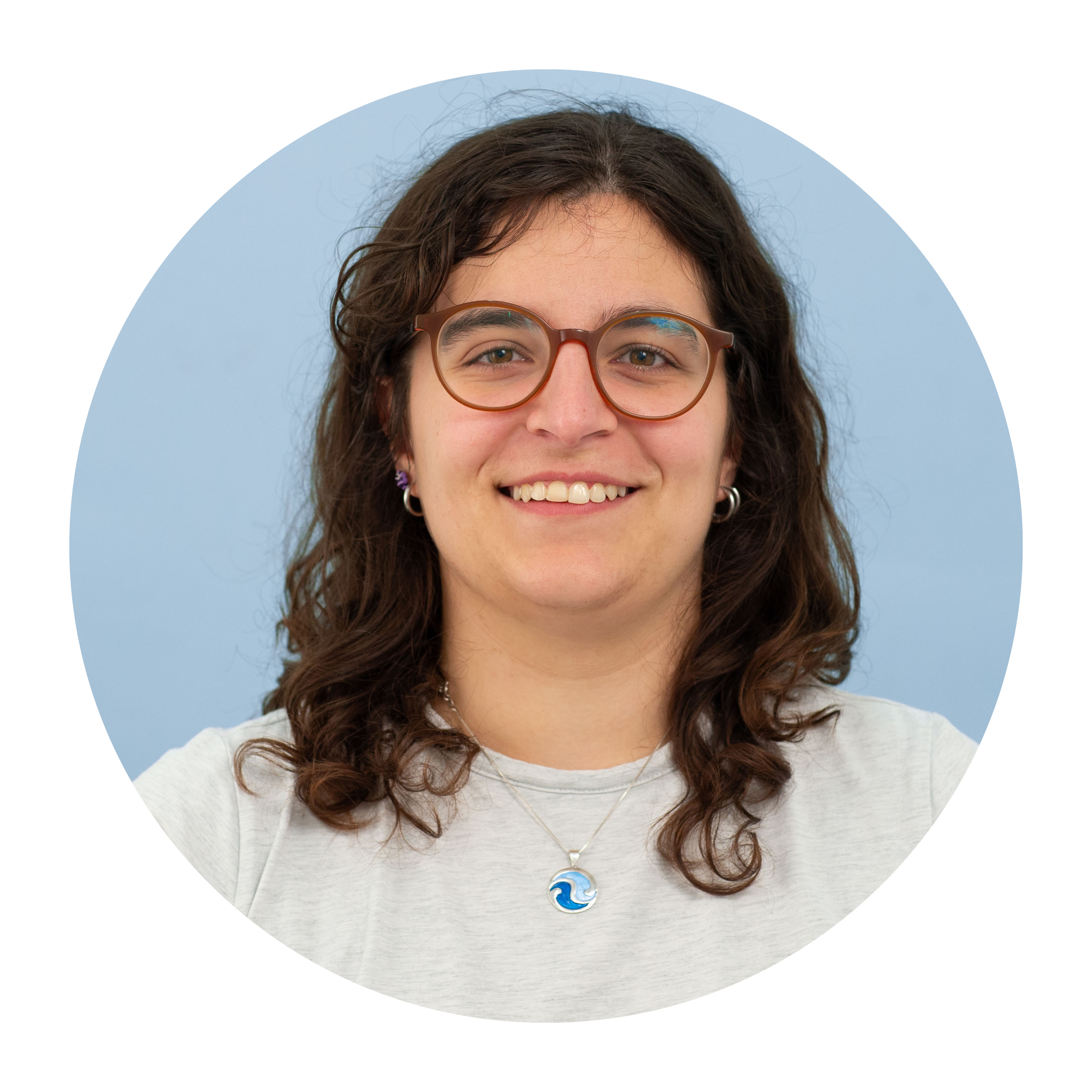 Portrait of Magdalena de Arriba Sanchez de la Campa, a white woman with mid-length brown hair worn loose, wearing glasses and white top, smiling broadly.