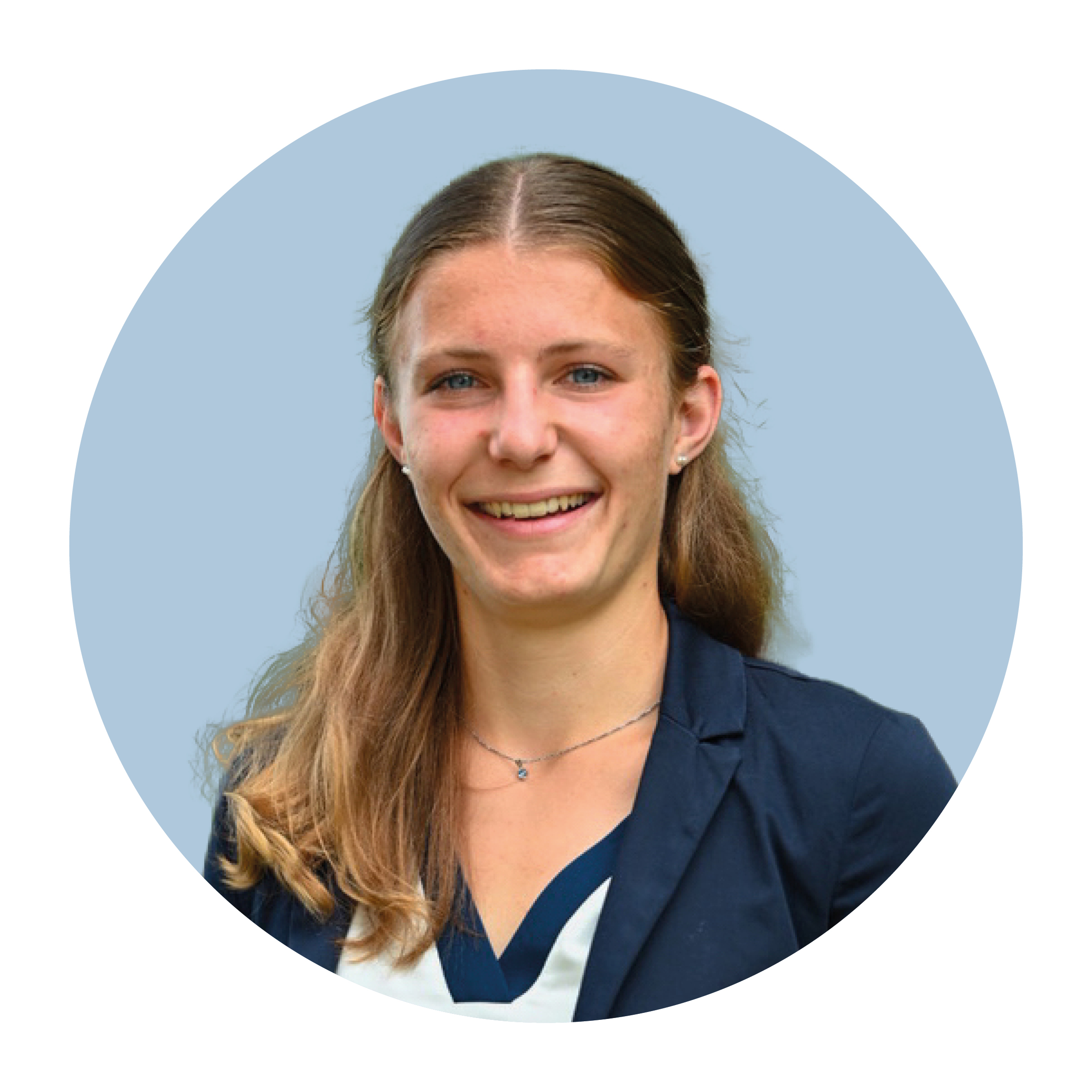 Portrait of Daphne Zubler, a white woman with mid-length light blonde or light brown hair, wearing a blue top and smiling broadly.
